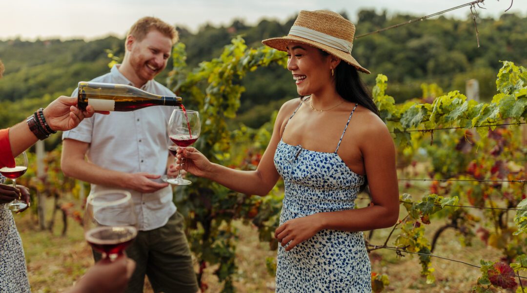 The image of people at the winery doing a tasting